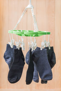 Close-up of socks drying against wall