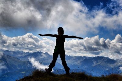 Silhouette of woman on mountain