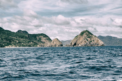 Scenic view of sea and mountains against sky