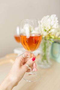 Close-up of hand holding glass of drink