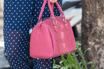 Girl holding a bag made of genuine python skin