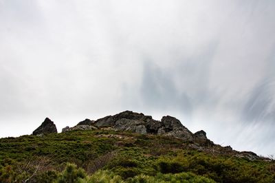 Scenic view of rock formations on mountain against sky