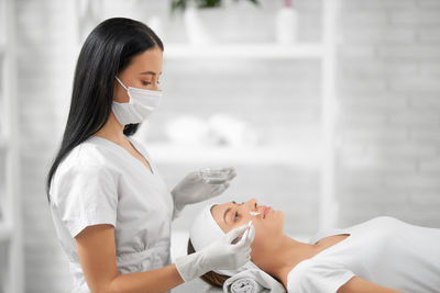 Woman doing face treatment at spa