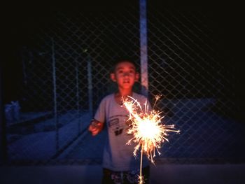 Man holding umbrella at night