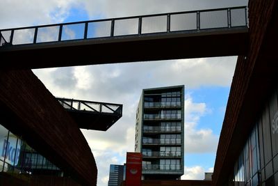 Low angle view of bridge against cloudy sky