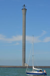 Sailboat in sea against sky