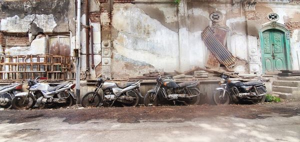 Bicycles parked against wall in city