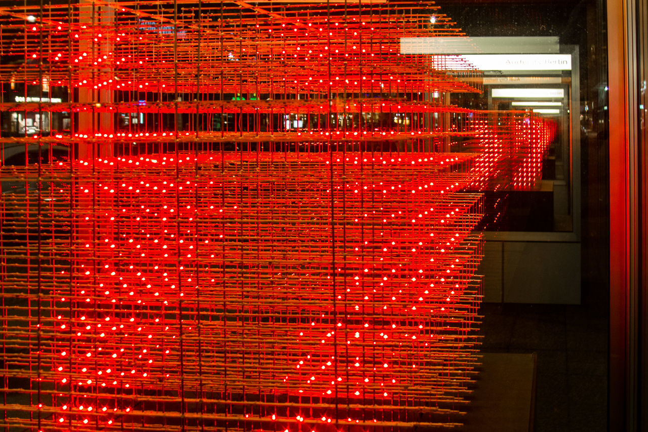 ILLUMINATED RED BRICK WALL IN CITY