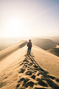 Full length of man standing on desert land