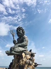 Low angle view of statue against sky