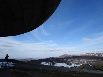 Scenic view of mountains against blue sky