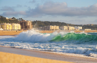 Big wave in atlantic ocean on the beach in nazaré, portugal.