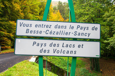 Close-up of information sign against trees