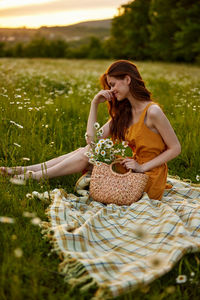 Young woman sitting on field