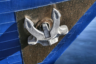 Close-up of metal against blue water