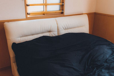 High angle view of sofa on bed at home