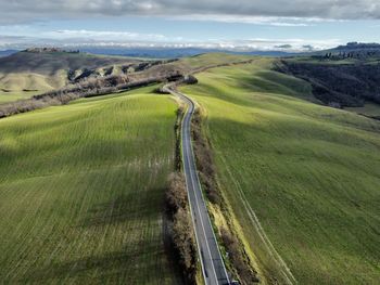 High angle view of road amidst land against sky