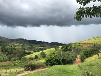 Scenic view of green landscape against sky