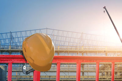 Close-up of yellow railing against clear sky during sunset