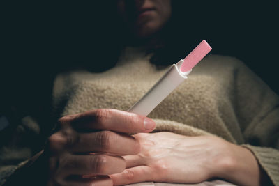 Close-up of hand holding cigarette