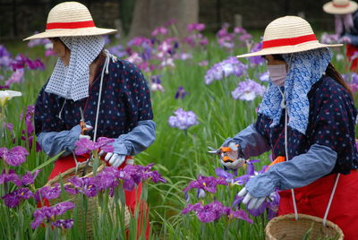 Women with flowers in field