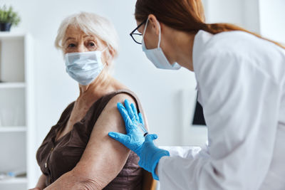 Midsection of woman wearing mask