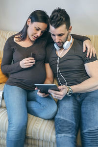 Young couple holding mobile phone