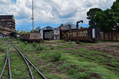 Railroad tracks amidst buildings against sky
