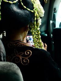 Rear view of man sitting in car