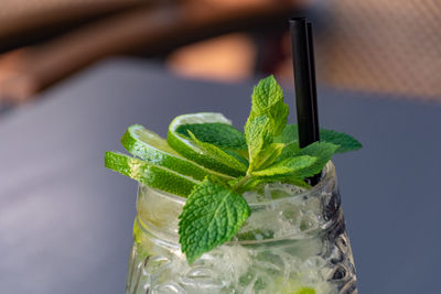 Close-up of mojito cocktail with mint leaves on a table in bar