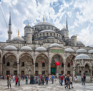 Group of people in front of historic building