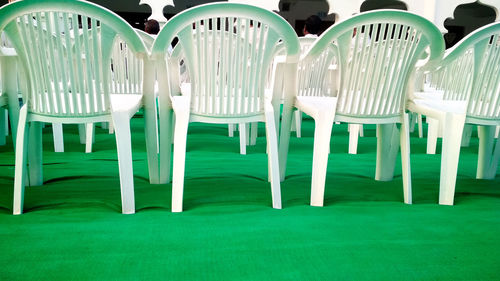 Empty chairs in grass