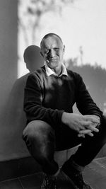 Full length of a man sitting outdoors