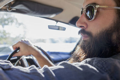 Handsome young man sitting in a car