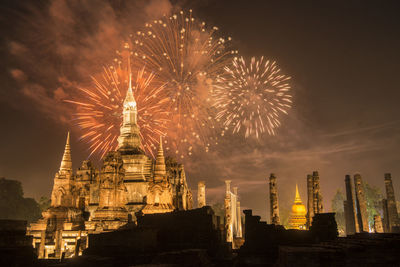 Low angle view of firework display against sky at night