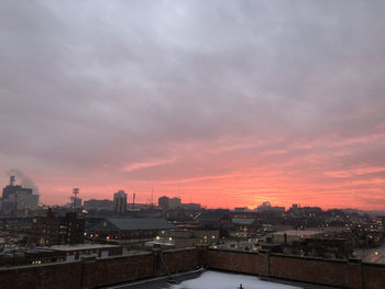 High angle view of buildings against sky at sunset