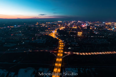 Illuminated buildings in city against sky at night