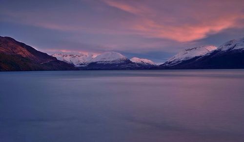 Scenic view of snow covered mountains against sky