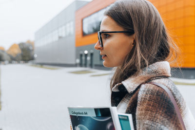 Portrait of young woman using mobile phone