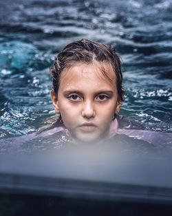Portrait of boy swimming in pool