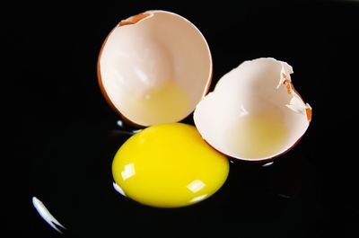 Close-up of yellow eggs against black background