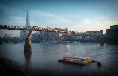 Bridge over river with city in background