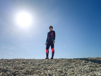 Full length of teenage girl standing on land against sky