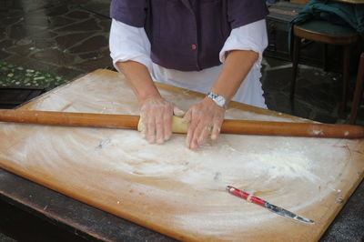 Midsection of man preparing food on table