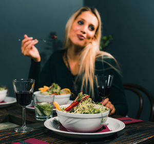 Close-up of a woman with drink on table