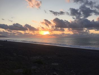 Scenic view of beach against sky during sunset