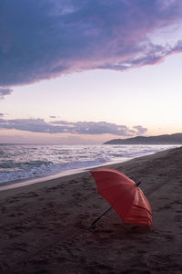 Scenic view of beach against sky during sunset