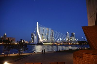 View of suspension bridge with city in background