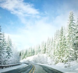 Road passing through snow covered landscape