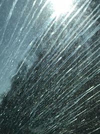 Full frame shot of raindrops on water